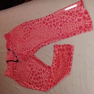 Women's Nike Dri Fit Work pant. These are anklet pant. Coral and peach colored.